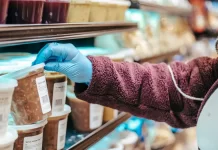 Czym różni się alergia pokarmowa od nietolerancji? Osoba w supermarkecie sięga po gotowy produkt z etykietą